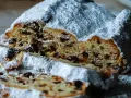 Ein saftiger Stollen, bestäubt mit Puderzucker, zeigt sein Inneres voller Rosinen. Ein köstliches Stollen Rezept zum Nachbacken.