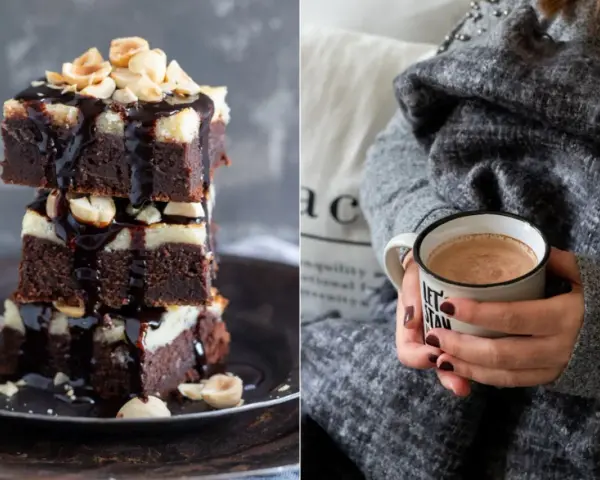 Gestapelte Cheesecake Brownies mit Schokoladenglasur und Nüssen, daneben eine Tasse Kakao.